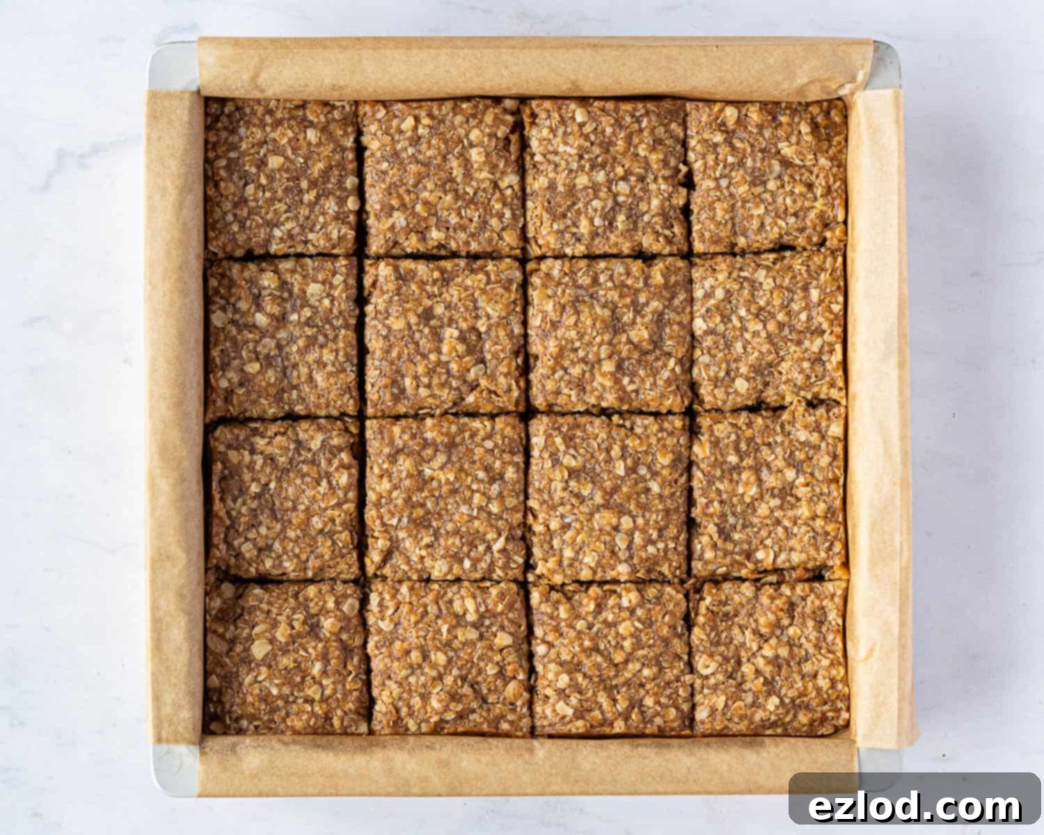 Step 5: The flapjacks, partially cooled and sliced into squares while still in the tin.