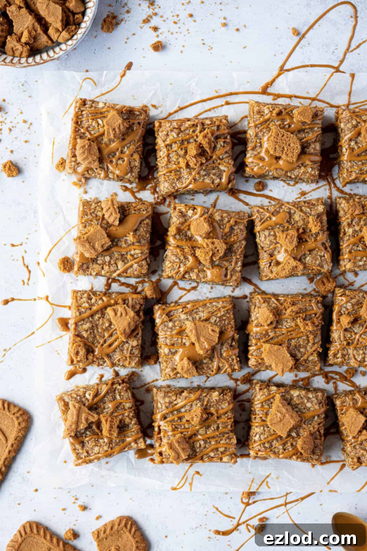 Biscoff flapjacks with Biscoff cookies on a white plate, ready to be served.