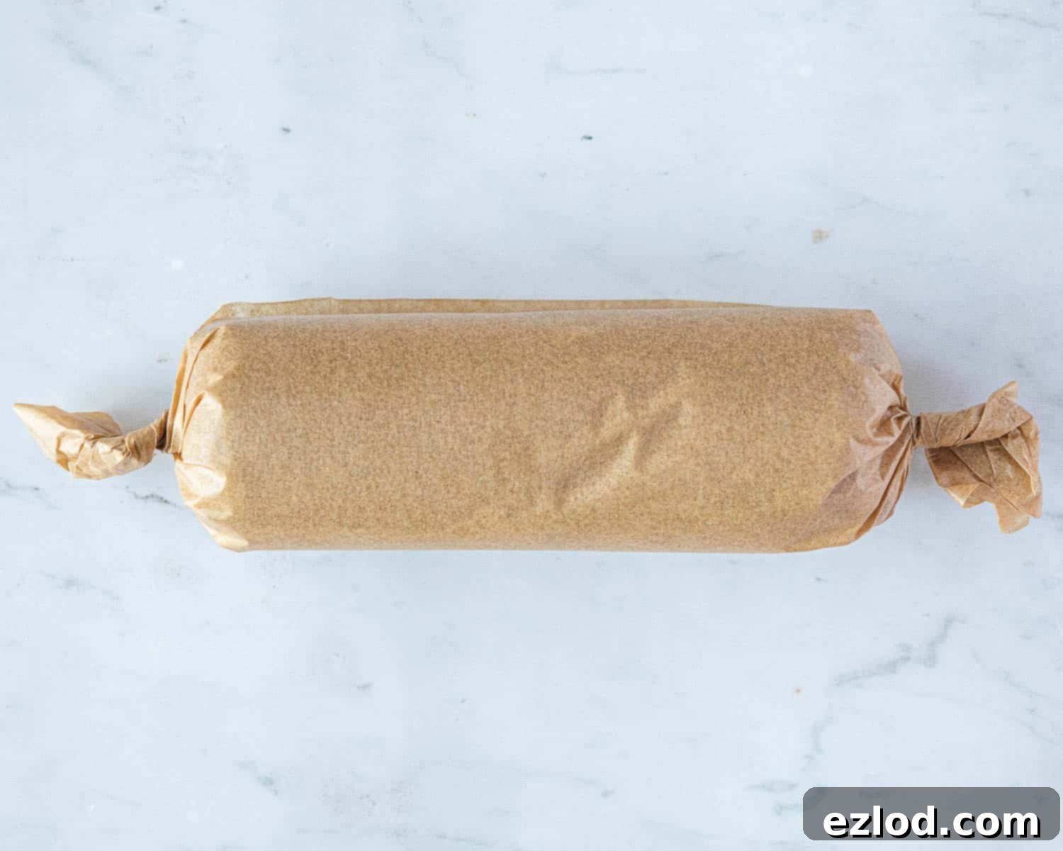 Step 5: The dough log is tightly wrapped in baking parchment, ready for chilling.