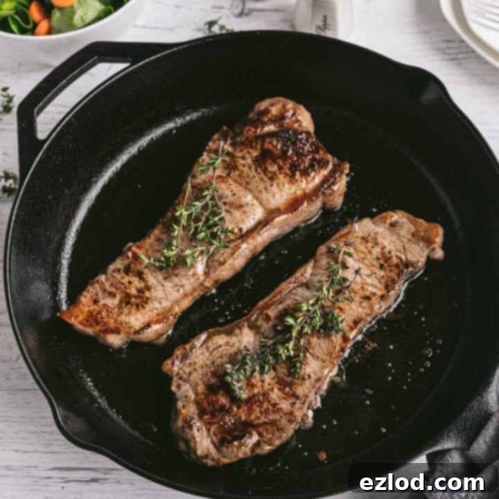 Perfectly seared New York Strip Steak on a cutting board, ready to be served.