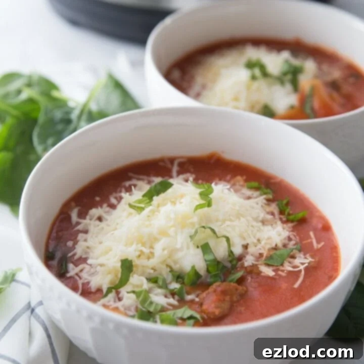 Hearty Instant Pot Lasagna Soup, garnished with fresh basil and cheese, served in a white bowl.