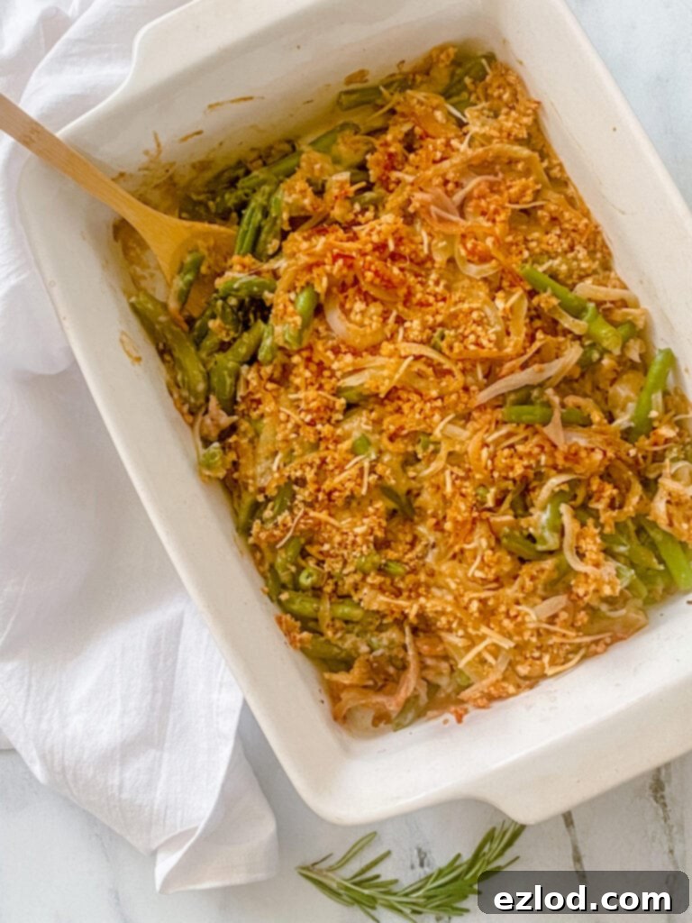 Wholesome Gluten Free Green Bean Casserole 6 Overhead photo: a beautifully baked healthy green bean casserole, generously topped with golden-brown crispy onions and creamy mushroom alfredo, ready for serving.