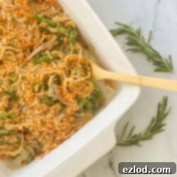 Wholesome Gluten Free Green Bean Casserole 8 A top-down view of the delicious Healthy Green Bean Casserole in a white dish, garnished and ready to serve.