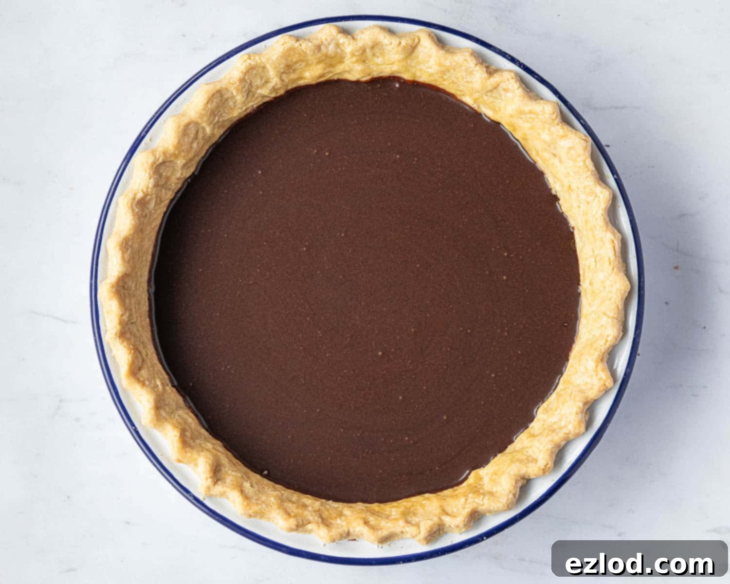 Step 7: The unbaked pie, with its rich chocolate filling poured into the blind-baked crust, ready for the oven.