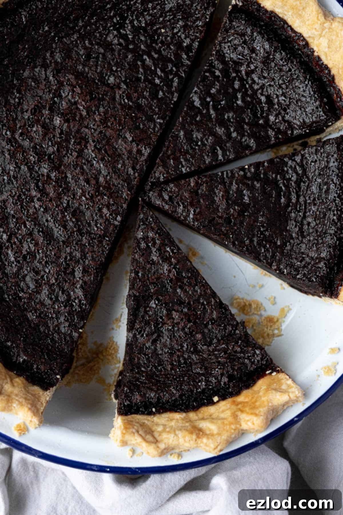 A close-up of a beautifully sliced vegan chocolate chess pie, revealing its rich, smooth filling texture.