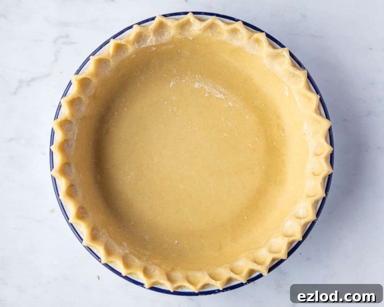 Step 2: The rolled-out pastry perfectly lining the pie dish, ready for chilling and blind baking.