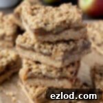 A stack of vegan apple crumble bars, golden and delicious.