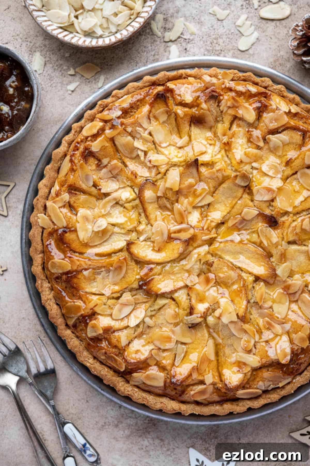 A close-up, overhead view of the vegan mincemeat frangipane tart, showcasing its golden crust and the texture of the frangipane filling.