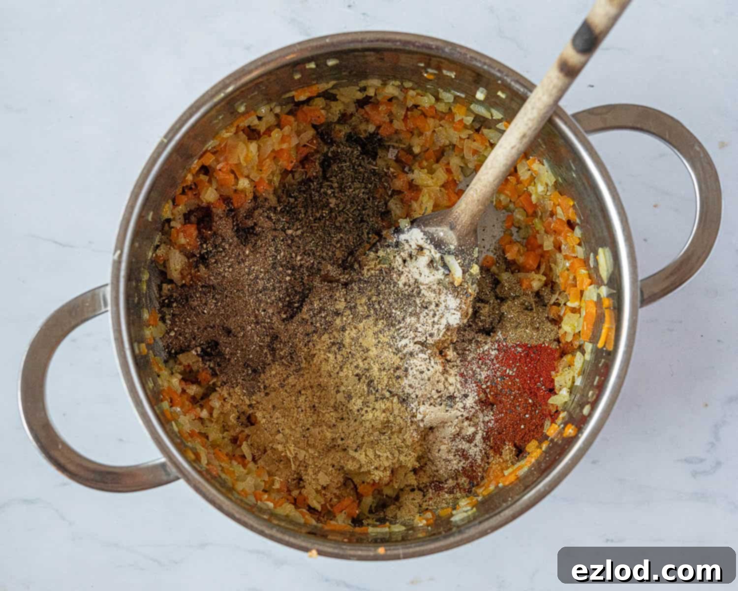 Step 2: Sautéed vegetables and spices for vegan seitan meatloaf in a pan.