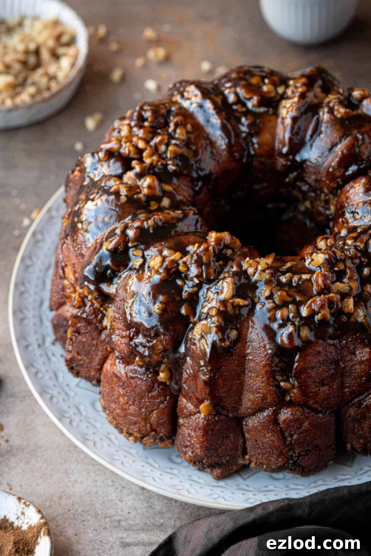 Vegan banana monkey bread on a white plate, showcasing its sticky, golden-brown texture.