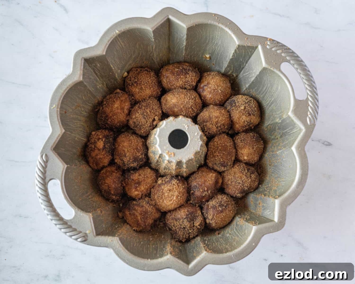 Step 8, the first layer of coated dough balls arranged in the bundt tin.