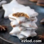 A stack of glazed vegan lebkuchen stars, one with a bite taken out of it.