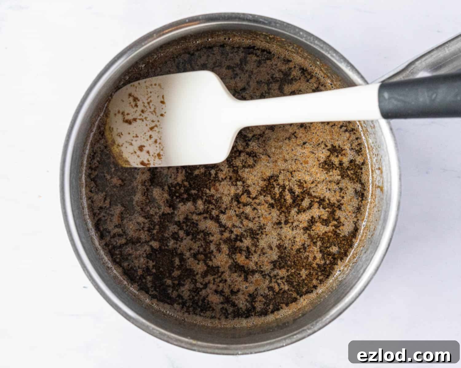 Step 1 in making vegan Lebkuchen: The melted wet ingredients, including golden syrup, treacle, vegan butter, and brown sugar, in a pan.
