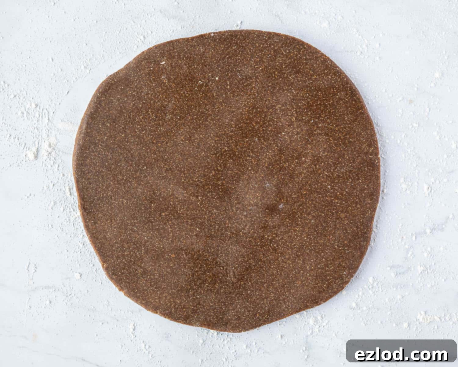 Step 4: The vegan Lebkuchen dough rolled out evenly on a lightly floured surface, ready for cutting.