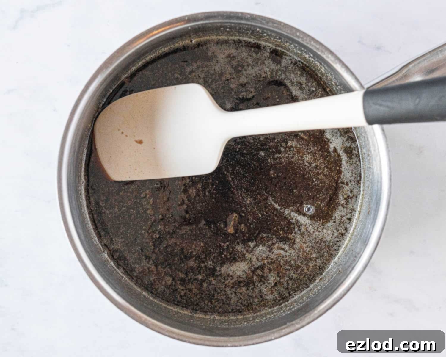 Step 1 in making vegan brunkager: melted vegan butter, brown sugar, and golden syrup in a saucepan, ready for the next ingredients.