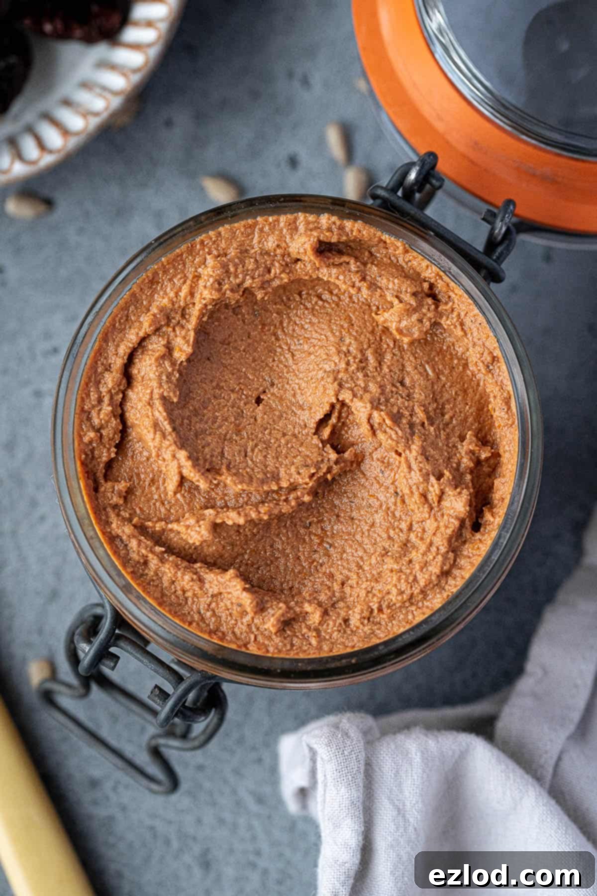 Vegan Tomato Sunflower Spread 7 Close-up of a glass jar filled with freshly made tomato sunflower seed pâté, showcasing its inviting color and smooth texture, ready for refrigeration.
