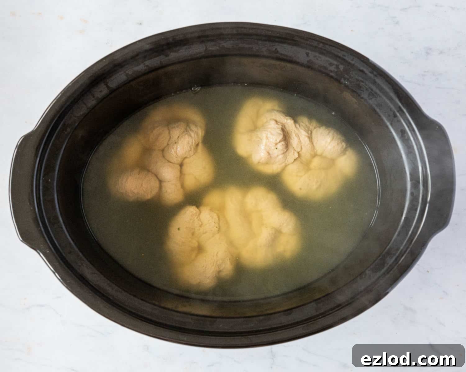 Step 8, adding the seitan to the slow cooker.