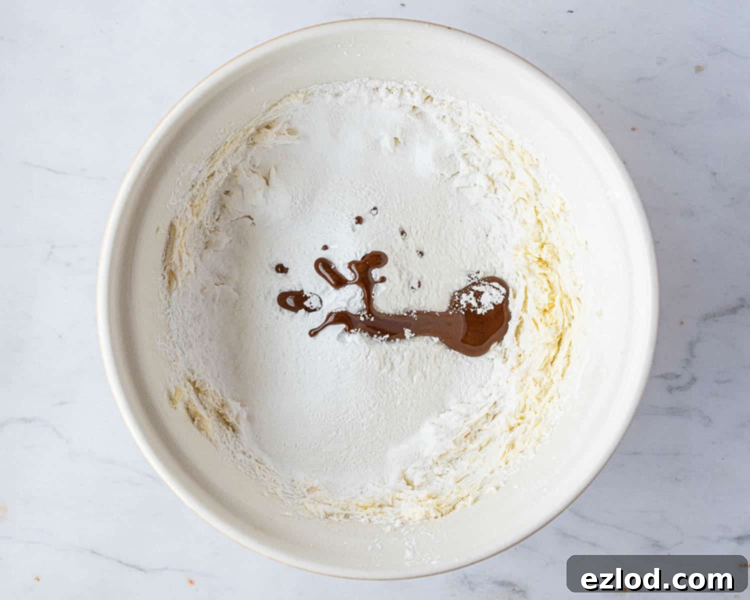Step 7: All buttercream ingredients in a bowl, ready to be whipped into a fluffy frosting for the cake.
