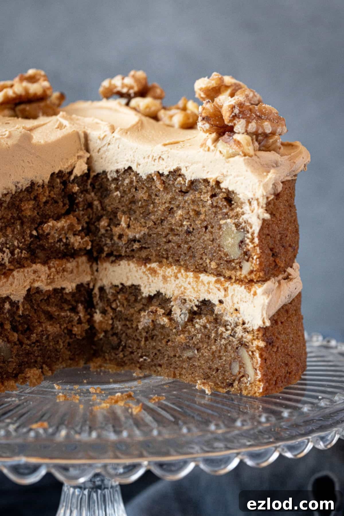 A close up of the sliced coffee and walnut cake showing the moist crumb and nuts.