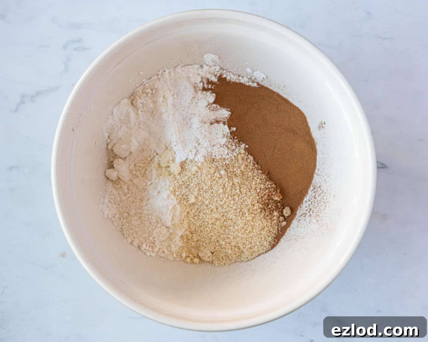 Step 1: Dry ingredients in a bowl, meticulously whisked together for the vegan and gluten-free coffee and walnut cake.