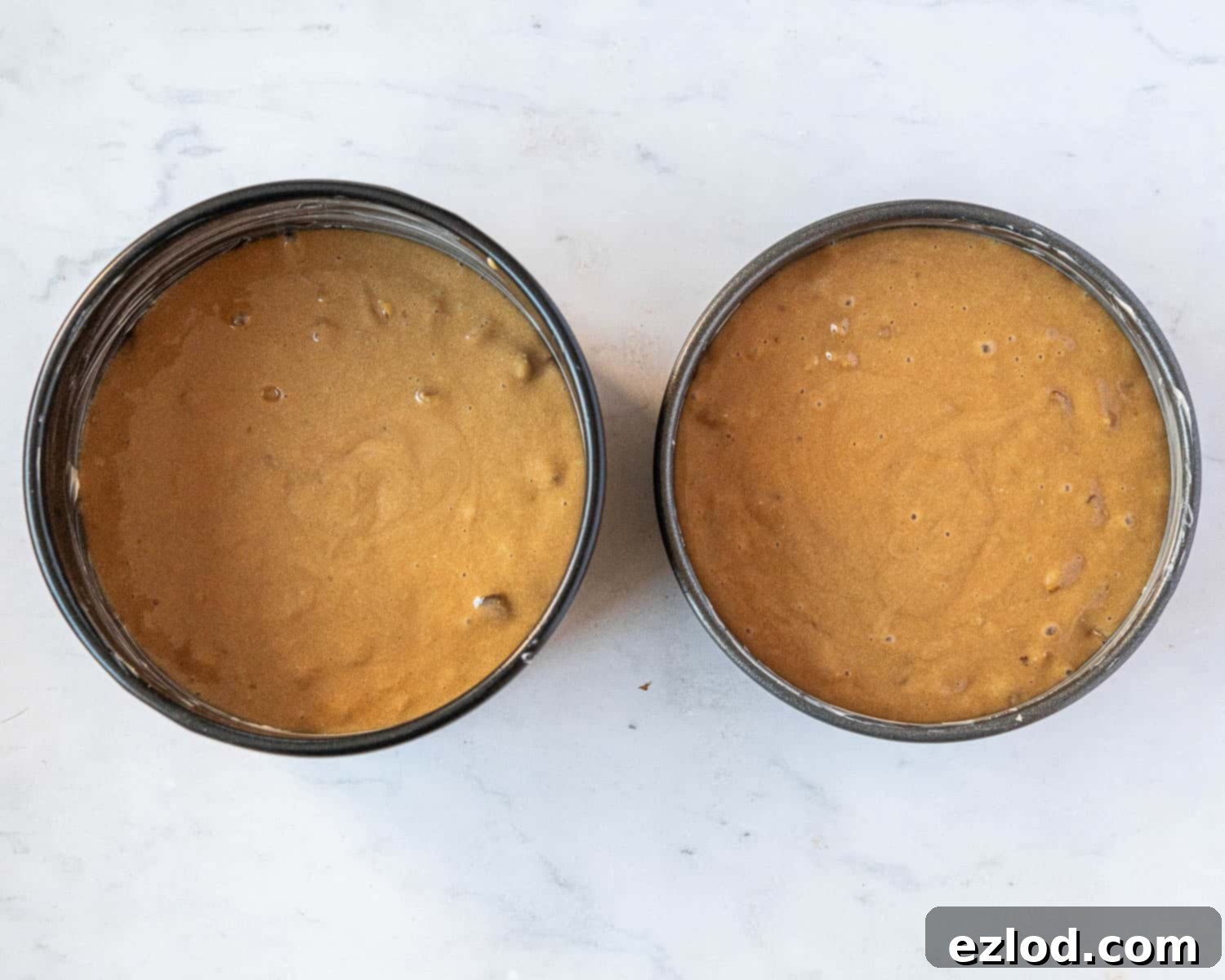 Step 4: The cake batter poured into prepared baking tins, ready to go into the oven.