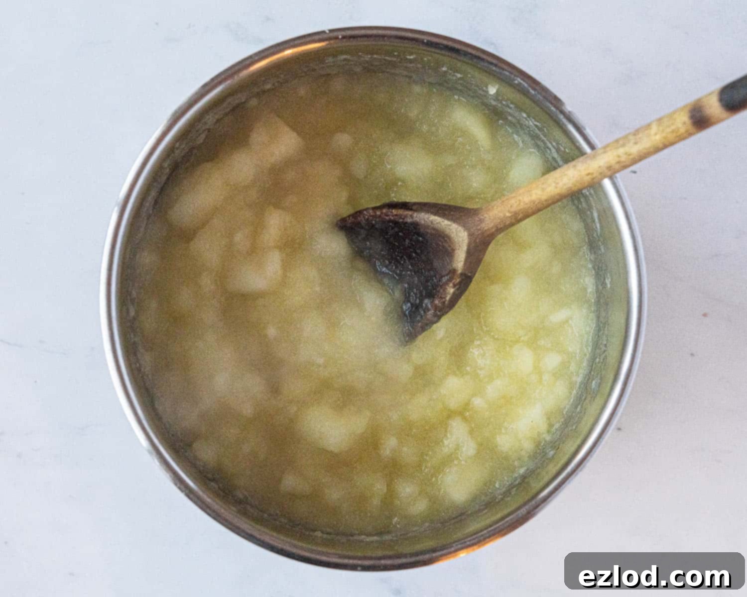 Softened, cooked apples in a saucepan, having just simmered, ready for blending into a smooth puree.