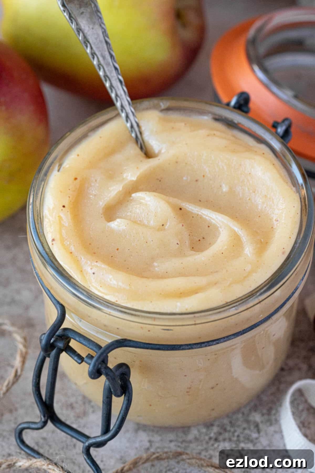 Close-up shot of a glass jar filled with luscious, creamy vegan apple curd, ready for refrigeration.