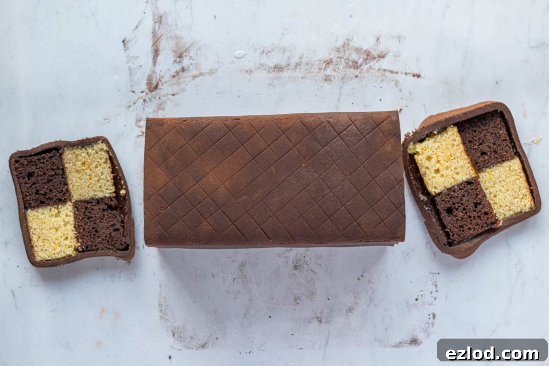 Decadent Vegan Chocolate Orange Battenberg 15 Step 11: Trimming the ends of the marzipan-wrapped cake to neaten it and reveal the signature checkerboard pattern.