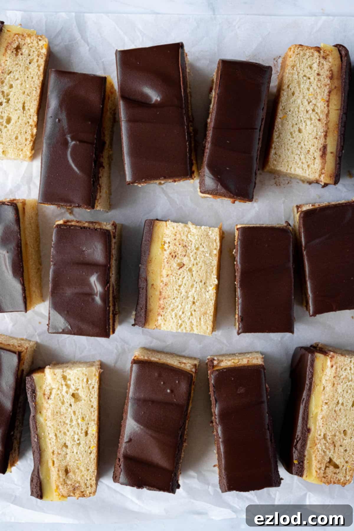 Vegann jaffa cake bars on a sheet of baking parchment.