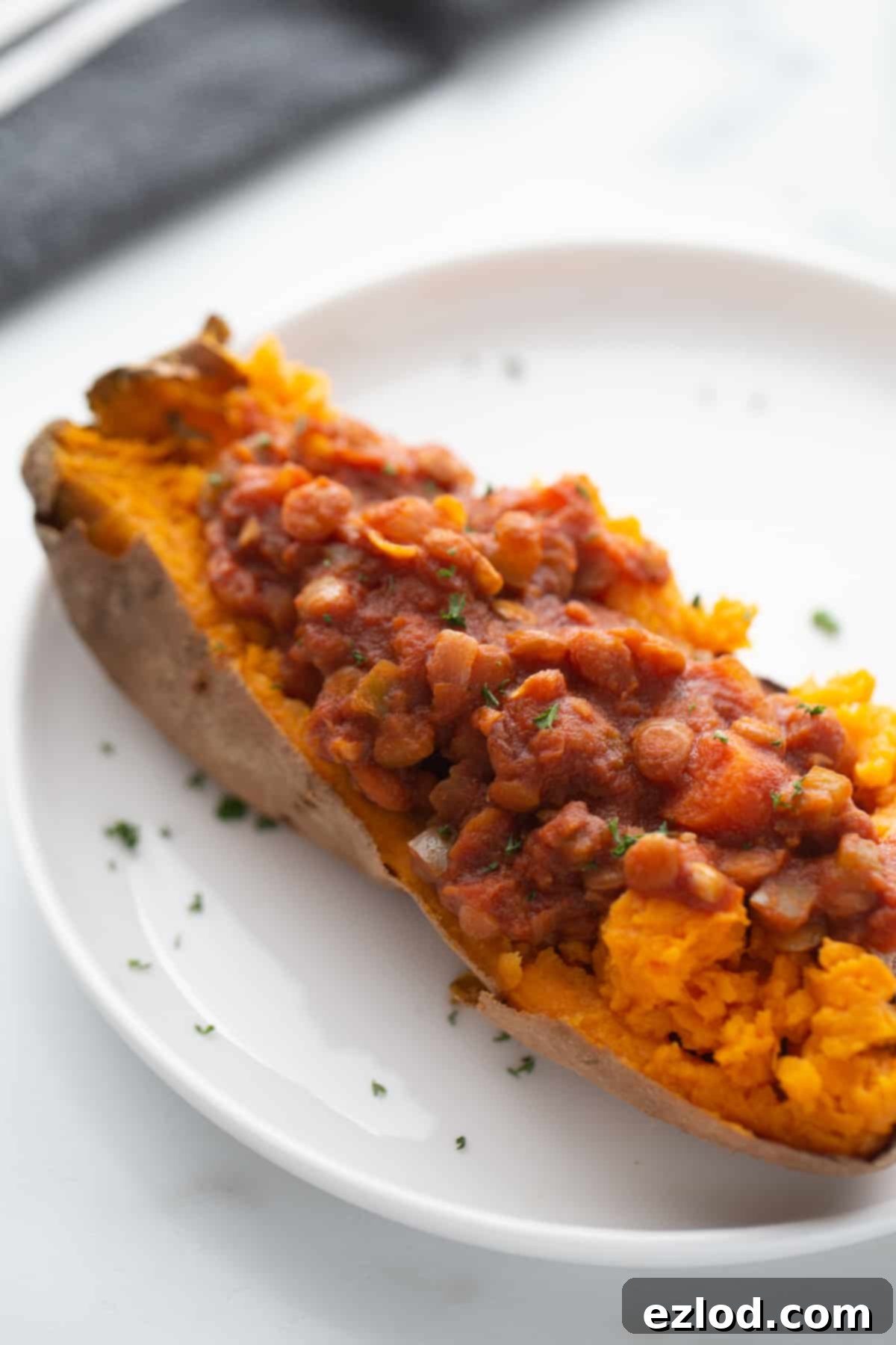 Instant Pot Lentil Sloppy Joes served open-faced on gluten-free buns, garnished with fresh parsley.