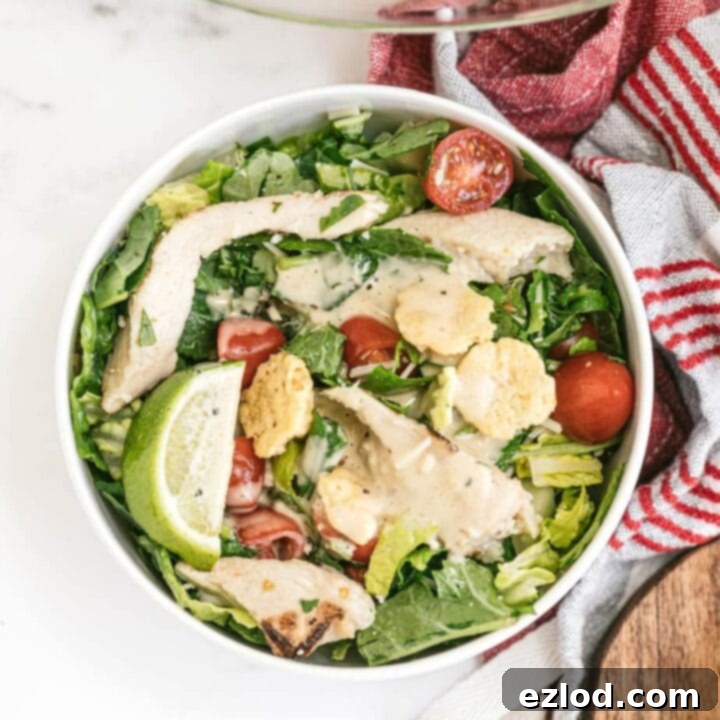 Fresh Kale Caesar Salad with chicken and dressing.