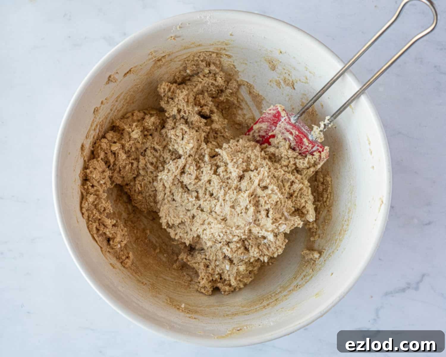 Step 3: The partially mixed cookie dough, showing the dry ingredients just incorporated into the wet mixture.