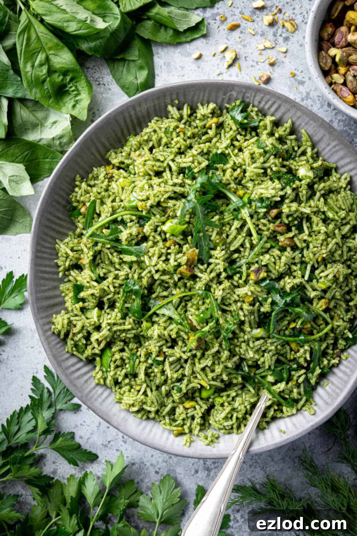 Close-up shot of a bowl of vibrantly green herby rice salad, highlighting its fresh appearance and texture.