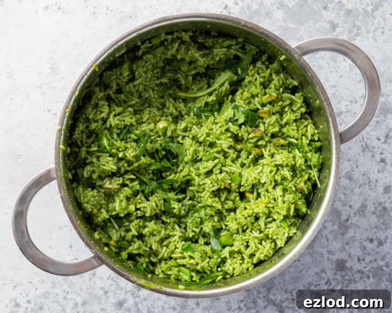 Step 3: The finished herby rice salad, beautifully mixed with herbs, pistachios, and rocket.