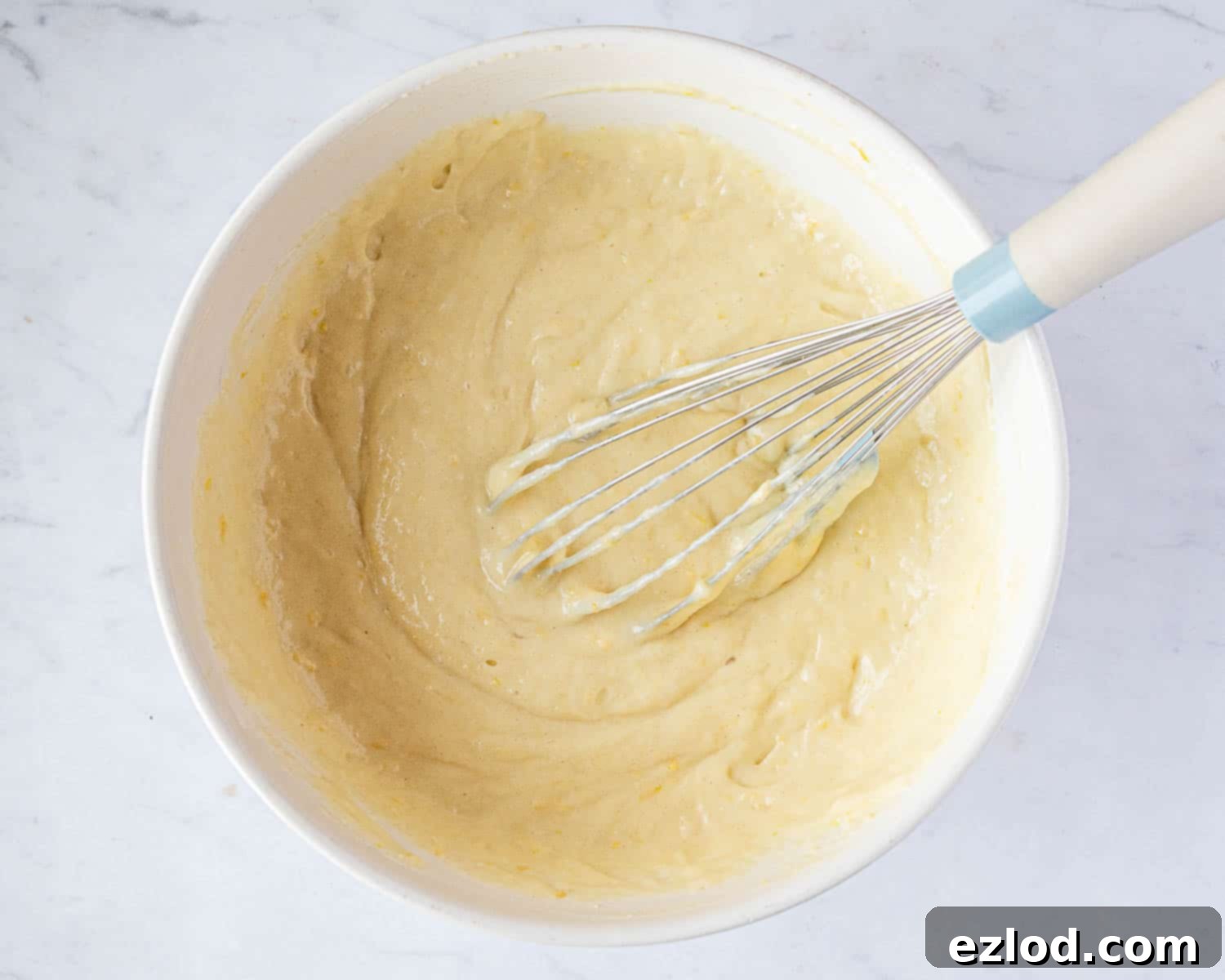 Step 2 in making gluten-free vegan lemon drizzle cake: The perfectly smooth, ready-to-bake cake batter in a mixing bowl.