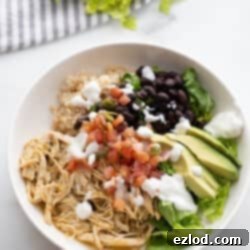 Effortless Salsa Verde Chicken Instant Pot or Slow Cooker 10 A recipe card image of a bowl of Easy Salsa Verde Chicken with various fresh toppings.