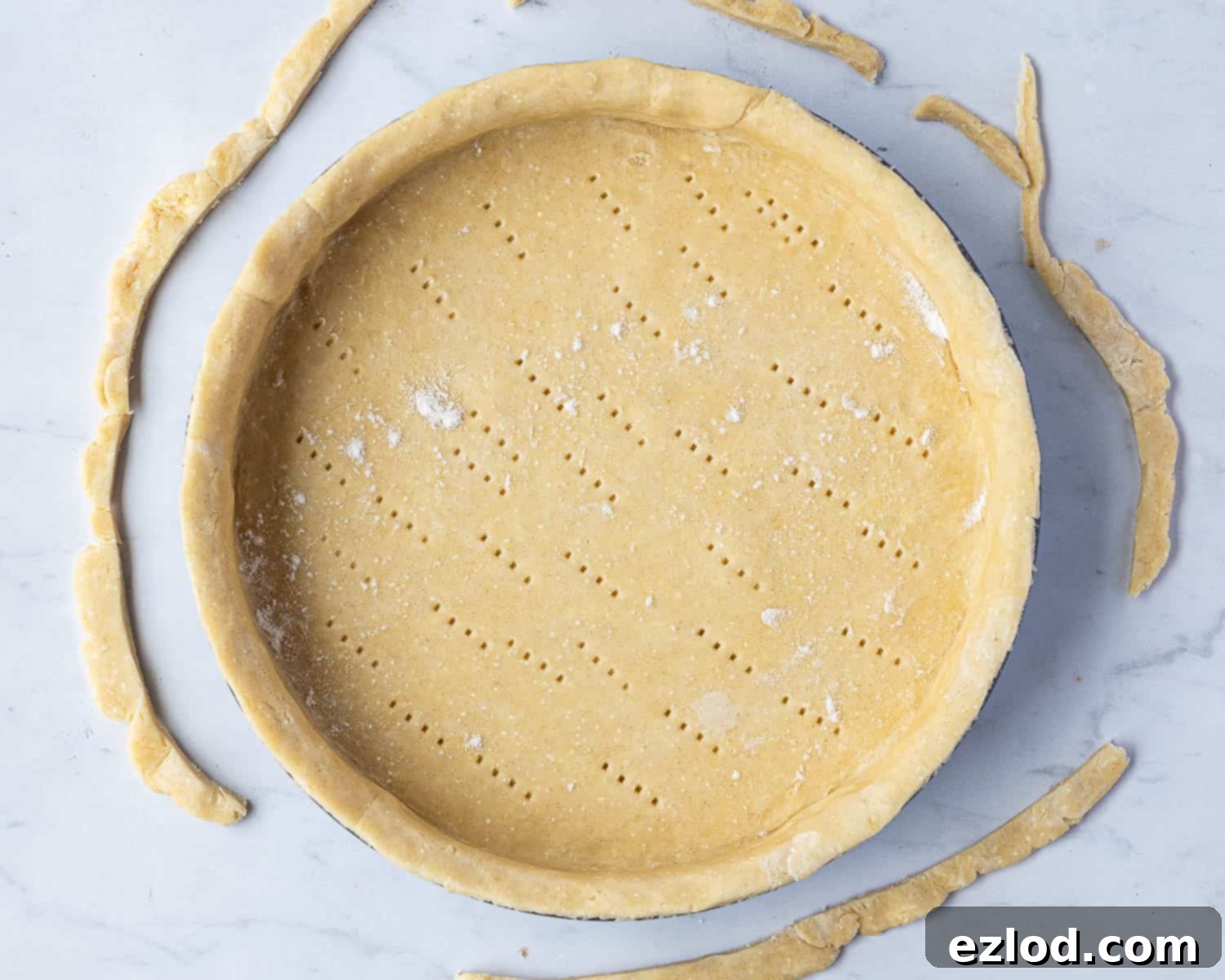 Step 3: The pie dish is perfectly lined with the rolled-out vegan pastry case, ready for blind baking.