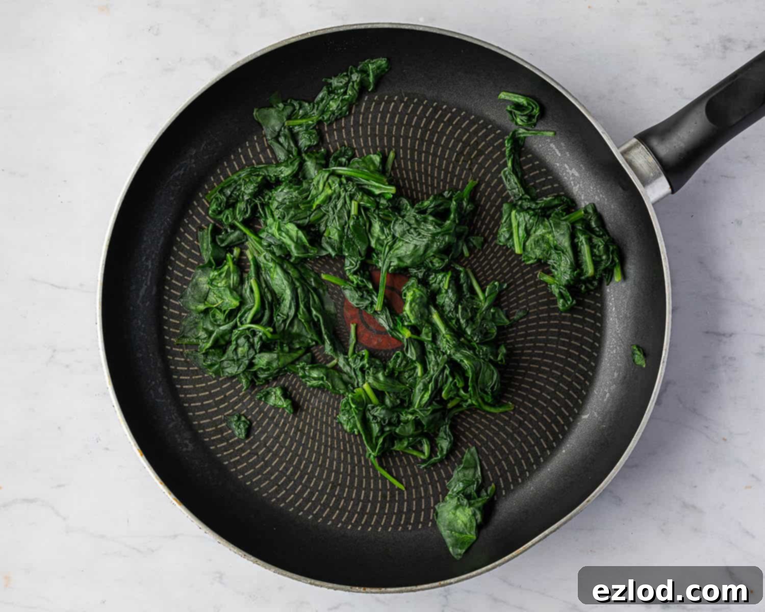 Step 6: Fresh spinach, perfectly cooked and wilted, ready for the next stage of preparation.