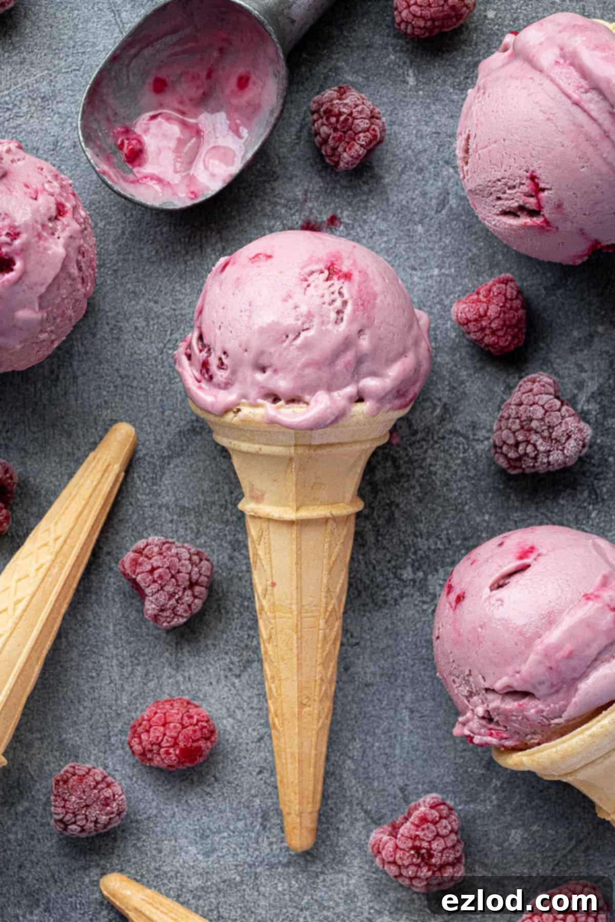A perfectly scooped cone of vegan raspberry ice cream.