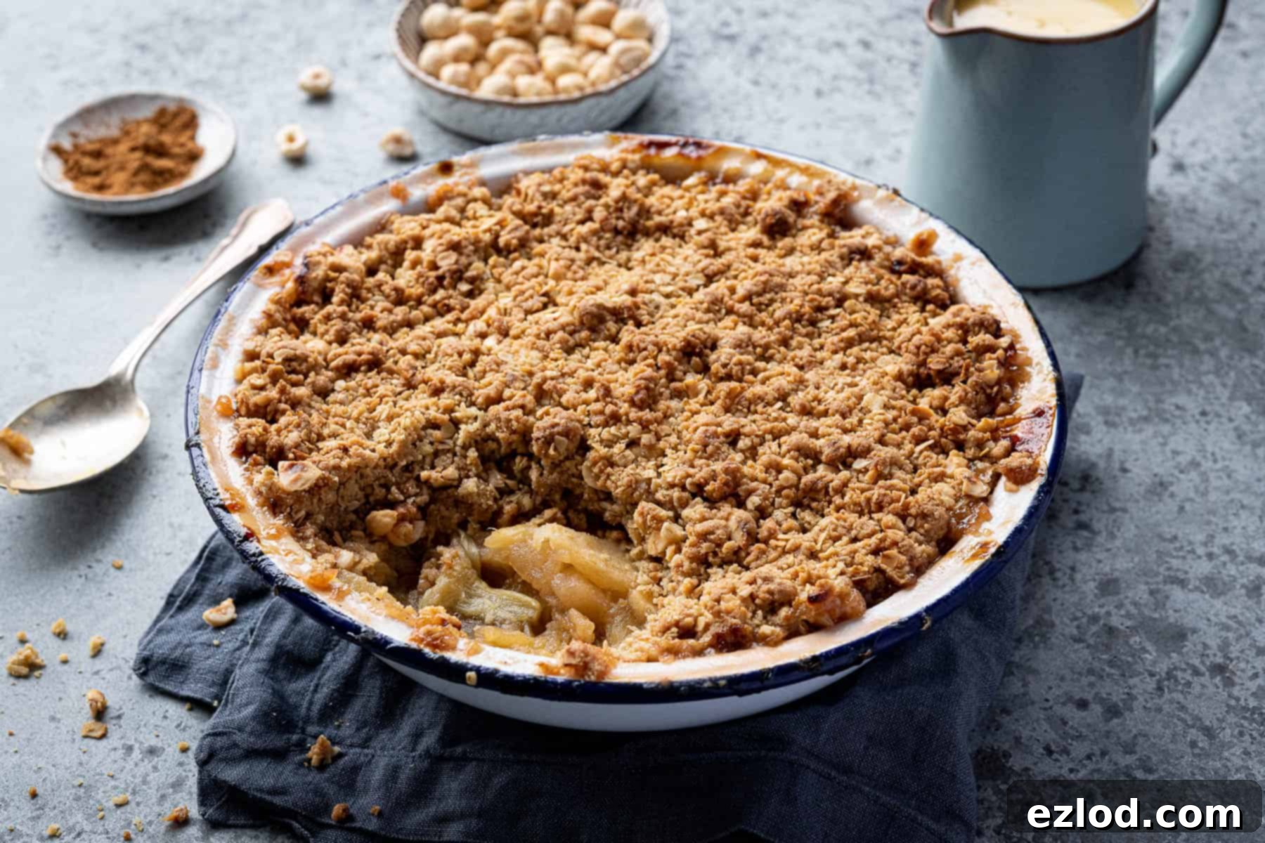 Rhubarb apple crumble in a dish with a spoonful removed.