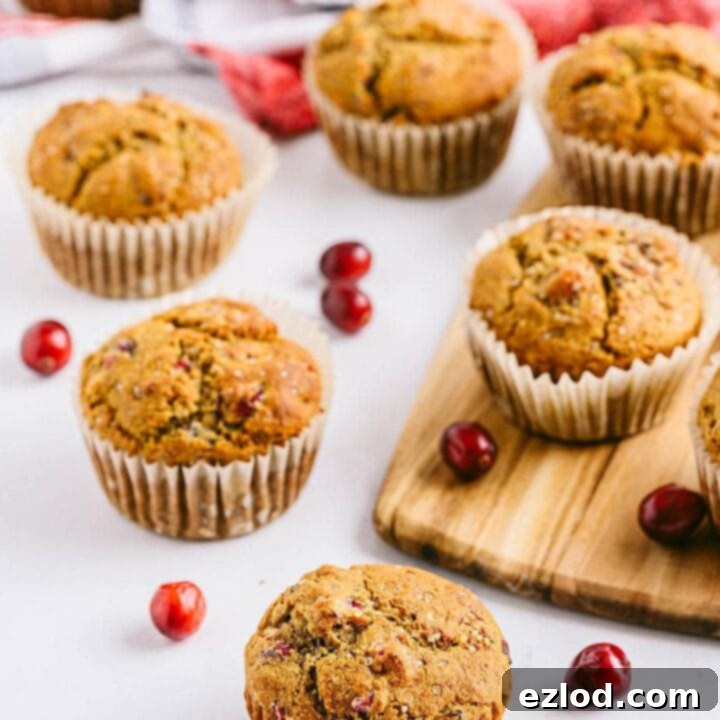 Fluffy Cranberry Orange Muffins with a sprinkle of raw sugar, served alongside hard-boiled eggs for a complete healthy breakfast
