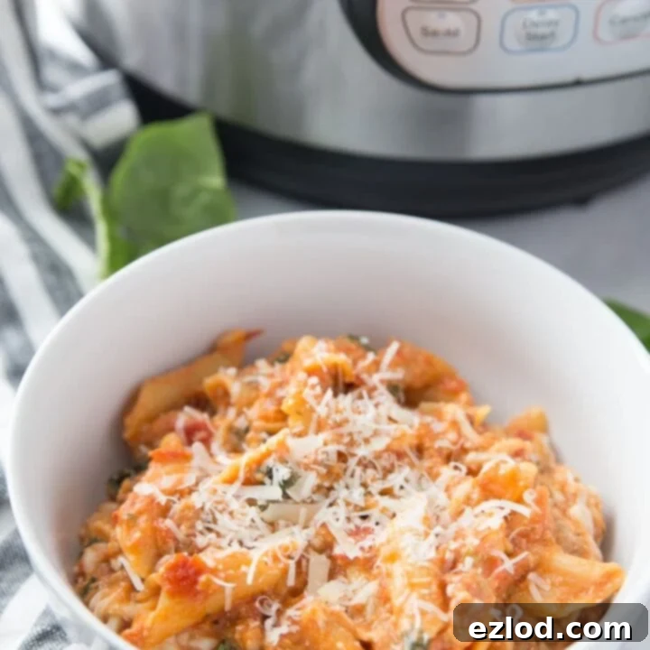 Hearty and healthy Instant Pot Baked Ziti, topped with melted cheese and fresh basil