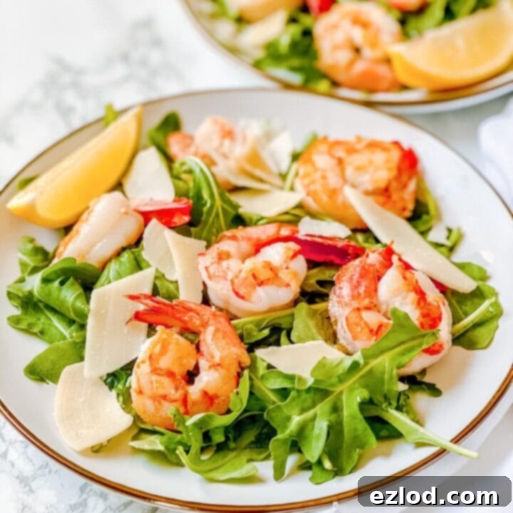 Fresh Lemony Arugula Salad with pan-seared shrimp and shaved parmesan, perfect for a light and healthy meal