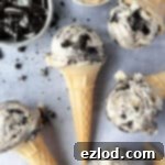 Cones of no-churn peanut butter oreo ice cream with bowls of peanut butter and crushed oreos.