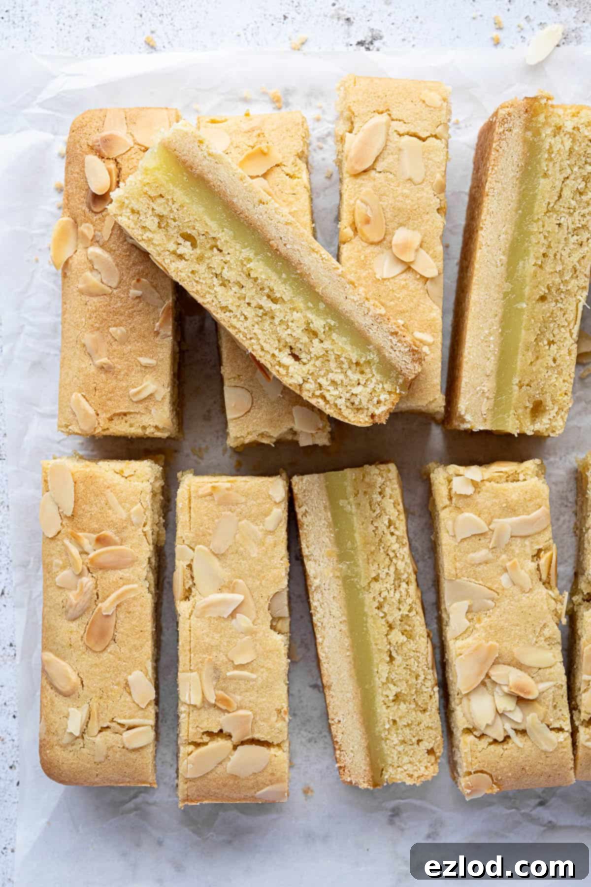 Zesty Vegan Bakewell Bliss 11 Sliced vegan lemon frangipane bars, beautifully revealing the layered texture of shortbread, lemon curd, and frangipane.