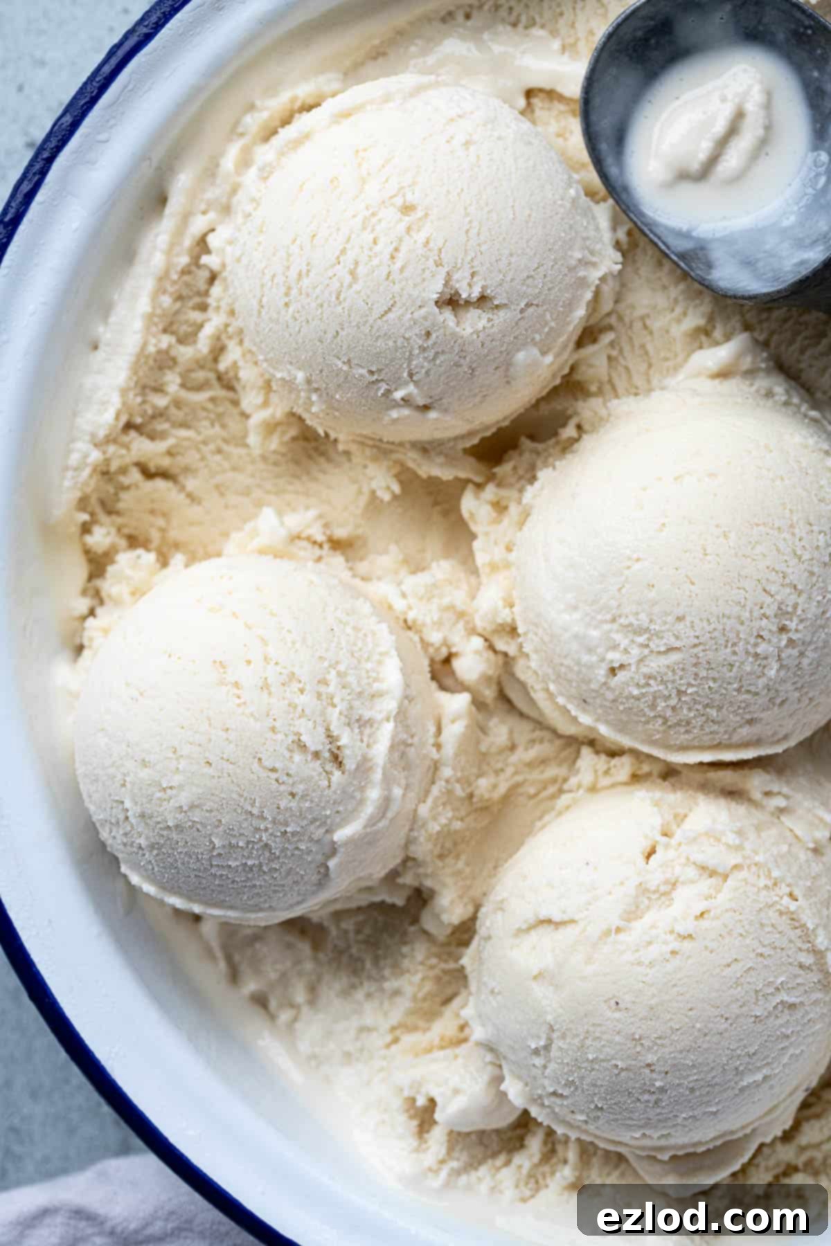Close-up of multiple scoops of creamy vegan rice ice cream in a dish, showing its appealing texture.