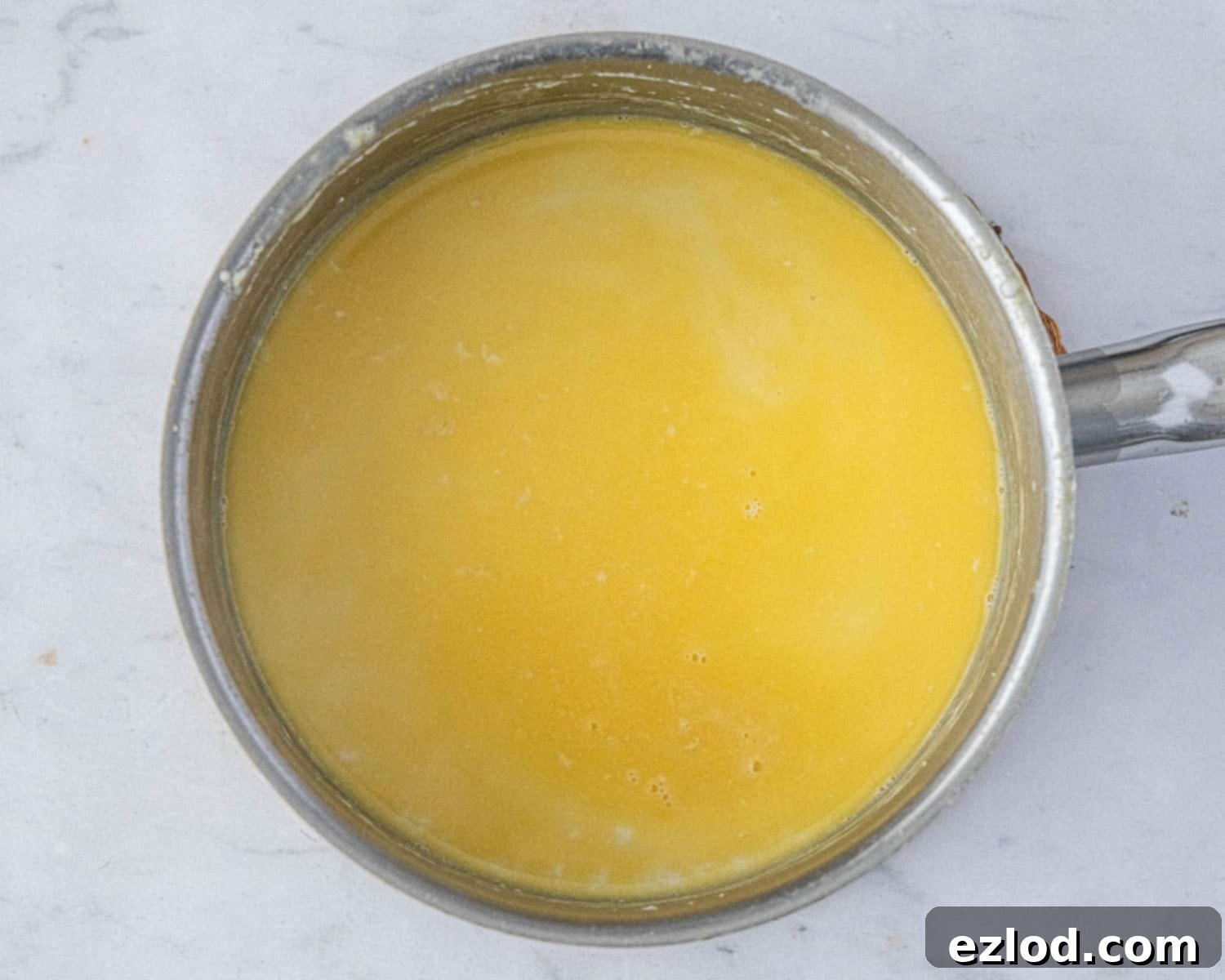 Step 2: Cooked rice with melted vegan butter stirred in, creating a creamy base.