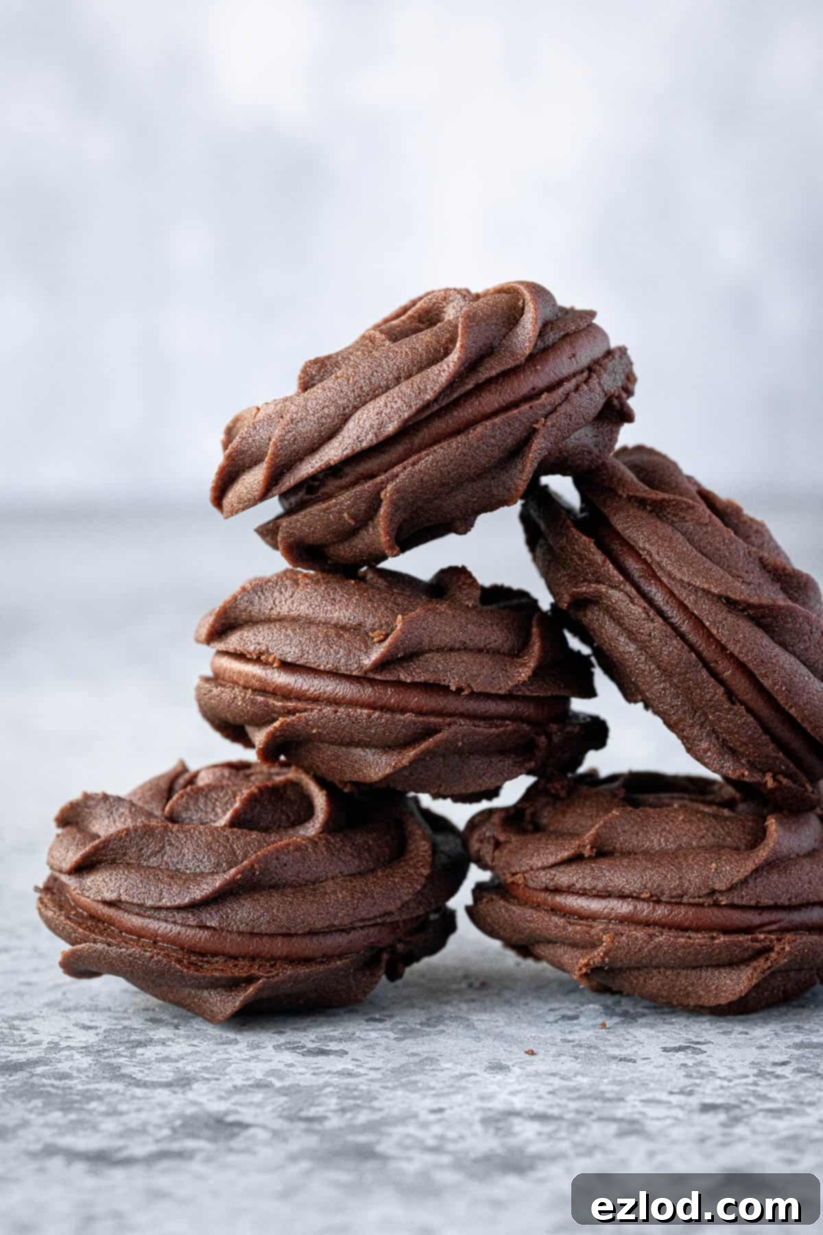 A stack of vegan chocolate Viennese whirl biscuits.