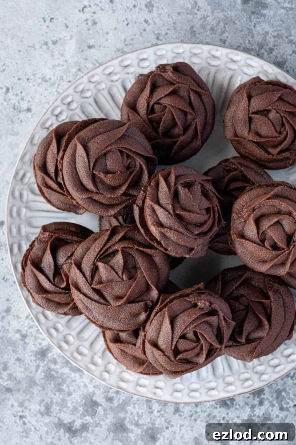A plate of chocolate Viennese whirl biscuits.