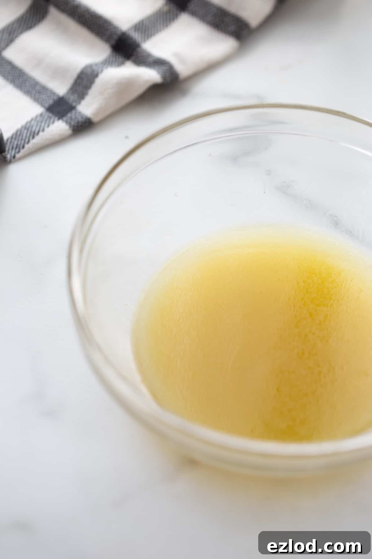 Salad dressing in a glass bowl, ready to be poured over the ingredients.